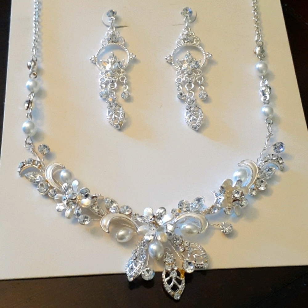 Silver Pearl an rhinestone necklace an ear rings .